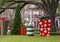 Sculptures of large Christmas gifts with bows and an undecorated Christmas tree before a mansion in Highland Park, Dallas, Texas