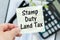 SDLT - Stamp Duty Land Tax write on a card on office desk
