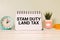 SDLT - Stamp Duty Land Tax write on a card on office desk