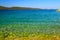 Sea background. Transparent, clear water on clean summer Blue flag beach. Rocks and beautiful sea. Croatian summer