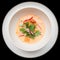 Sea bass ceviche shot from above, isolated on black