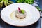 Sea bass tartare with toasted bread on a white plate