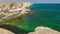 Sea bay of emerald color near coastal cliffs