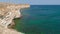 Sea bay of emerald color near coastal cliffs