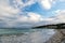 Sea beach on cloudy sky in philipsburg, sint maarten. Seascape with town on mountain landscape, nature. Beach vacation at Caribbea