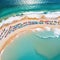 Sea beach with colorful umbrellas and relaxing aerial top Crowded sandy beach at high Tourists at summer Created with