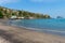 Sea beach with dark sand and villas