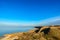 Sea beach with small rocky lagoon and coastal grass. Deep blue sky. Russia Azov sea