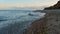 Sea beach at sunset. Ocean water waves splashing sand coast. Nature background