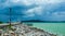 Sea beach walkway and beautiful dark clouds background at Khao Lam Ya, Rayong, Thailand.