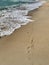 Sea beautiful blue and footprints in the sand