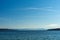 Sea and blue sky on sunny day with the alps in background at Starnberg lake near munich in Germany