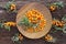 Sea buckthorn background. Organic ripe sea buckthorn on old wooden plate, rustic background. Top view