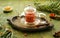 Sea buckthorn berries prepared for brewing in a glass teapot on a green concrete background. Sea buckthorn tea