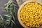 Sea buckthorn. Fresh ripe berry in wooden bowl with leaves on wood background