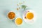 Sea buckthorn in porcelain bowl, honey and cup of  tea with Sea buckthorn on blue table