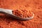 Sea buckthorn powder with seeds on a wooden spoon, close up