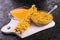 Sea buckthorn rubbed with honey in a glass bowl on a black background. Sea buckthorn jam.