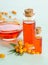 Sea buckthorn and two bottles, bowl with sea buckthorn oil