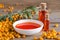 Sea buckthorn and two bottles, bowl with sea buckthorn oil