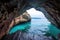 sea cave opening to a calm, turquoise sea