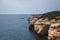 Sea Caves, Rocky Coast with a city above