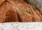 Sea cliff with Devonian sandstone outcrops. During the storm, niches and caves were washed away in the sandstones, sandstone