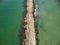 The sea cliff seen from above. The waves hit the old cliff. A summer day when the sea is blue and quiet