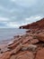 Sea cliffs under an overcast sky at Cavendish Beach, Prince Edward Island, Canada. Vertical shot