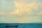 Sea, clouds, boat, rainbow. Nusa Dua Bali. Geger Beach. Indonesia.