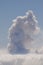 Sea of clouds and smoke plume from a volcanic eruption.