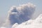 Sea of clouds and smoke plume from a volcanic eruption.