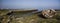 sea coast with blue sky and broken old damaged boa