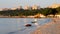 Sea coast early morning summer. Blue sea sandy beach sea buildings green trees