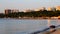 Sea coast early morning summer. Blue sea sandy beach sea buildings green trees