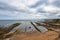 Sea coast of the Scottish town of Saint Andrews with its rock formations that penetrate the sea.