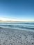 Sea coast with seashells and texture waves, sea lanscape.