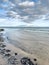 Sea coast with seashells and texture waves, sea lanscape.