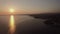 Sea and coastal town at sunset, aerial. Distant view of Trikorfo Beach, Greece