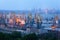 Sea commercial port at night in Mariupol, Ukraine. Industrial view. Cargo freight ship with working cranes bridge in sea port