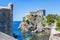 Sea cove and city wall tower under Fort Lovrijenac in Dubrovnik, Croatia