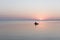 Sea at dawn with fishing rubber boat, calm.