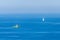 Sea fisher ship and sailboat in a sea. Minimalist view