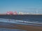 Sea fishing at low tide in the River Mersey - the Port of Liverpool container facility is in the background.