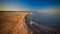 Sea foam at the beach of the Aral Sea near Aktumsuk cape at sunset, Karakalpakstan, Uzbekistan