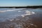 Sea foam washing up on the beach in Kent, UK