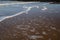 Sea foam washing up on the beach in Kent, UK