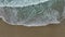 Sea Foamy Water Waves Crashing On Sandy Beach