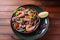 Sea food salad with shrimps, avocado, cherry tomatoes, red hot chilly pepper, red onion, arugula, beet leaves,