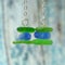 Sea glass dangle earrings of rustic background. Close up. Handmade jewelry